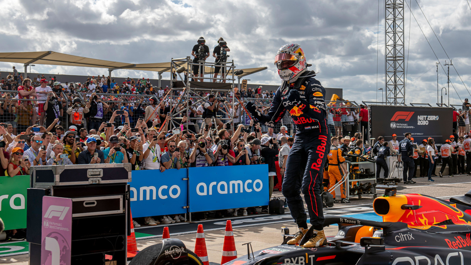 Max Verstappen standing on the car celebrating the win. Austin October 2022