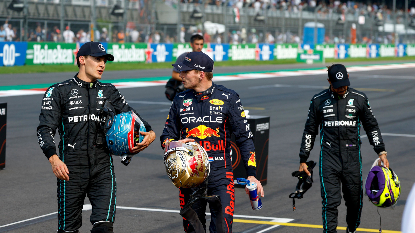 Max Verstappen speaking with George Russell, Lewis Hamilton in the background. Mexico October 2022