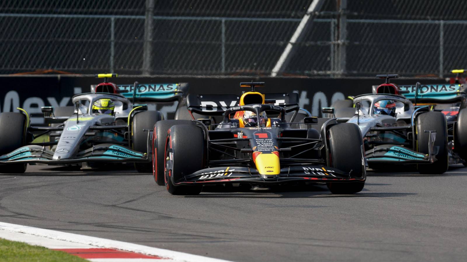 Lewis Hamilton and George Russell, Mercedes, pursue Max Verstappen, Red Bull. Mexico, October 2022.