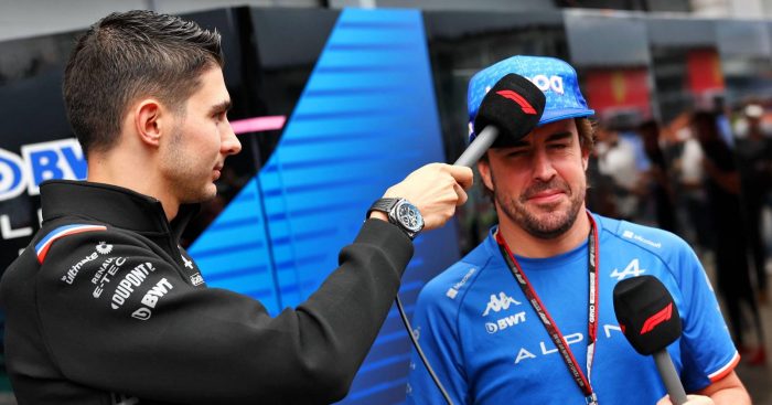 Esteban Ocon, Alpine, taps Fernando Alonso with a microphone. Brazil, November 2022.