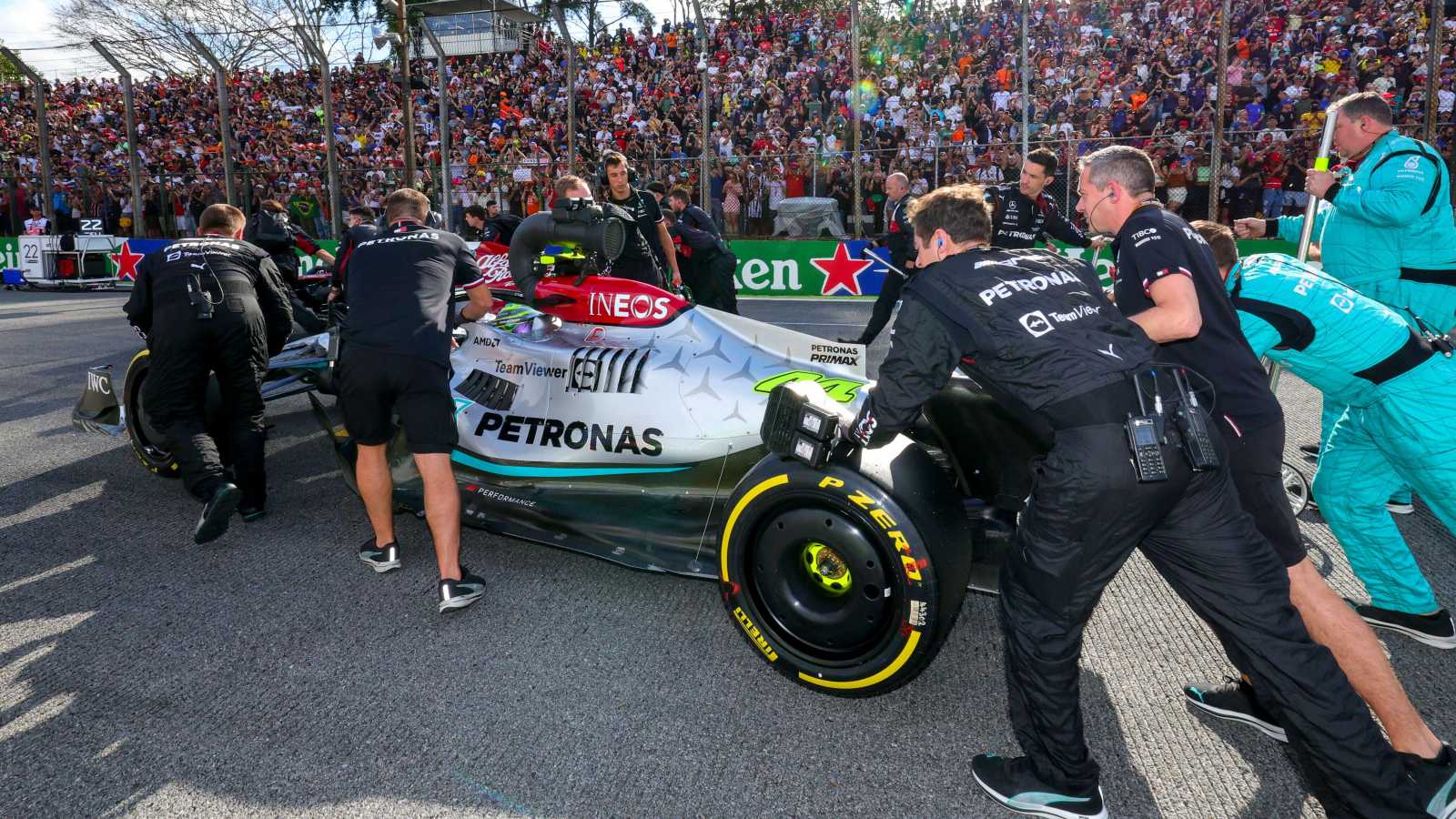 Mercedes mechanics push Lewis Hamilton into place. Brazil, November 2022.