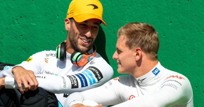 Daniel Ricciardo sitting against the pit wall chatting to Mick Schumacher. Belgium August 2022