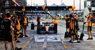 Lando Norris with the slippery patch on the McLaren pit box. Abu Dhabi November 2022