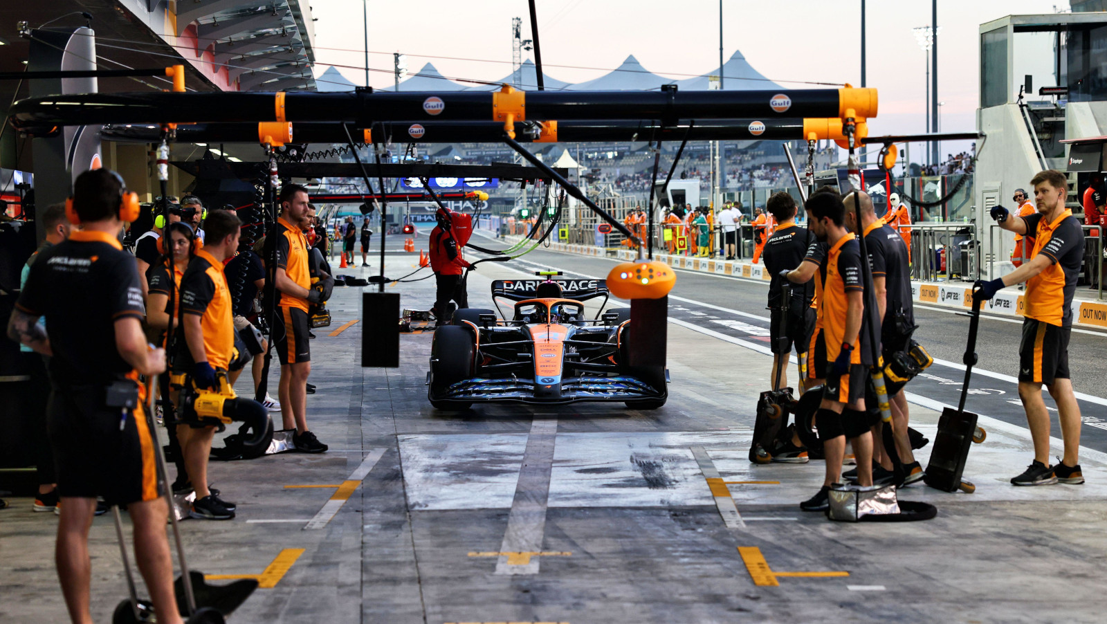 Lando Norris with the slippery patch on the McLaren pit box. Abu Dhabi November 2022