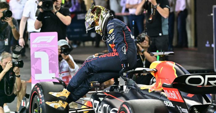 Max Verstappen hops out of his RB18 with the No1 board. Abu Dhabi November 2022