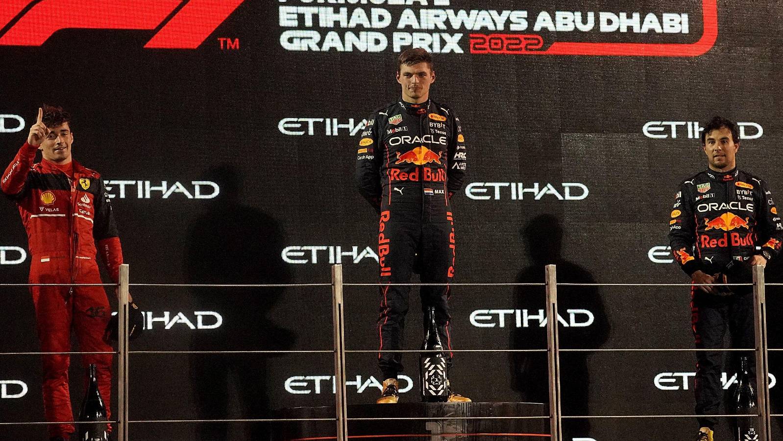 Max Verstappen, Charles Leclerc and Sergio Perez on the podium. Abu Dhabi November 2022.