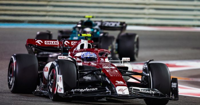 Guanyu Zhou running ahead of Sebastian Vettel under lights. Abu Dhabi November 20222