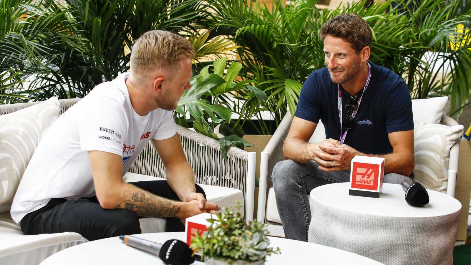 Kevin Magnussen and Romain Grosjean chat together. Miami May 2022.