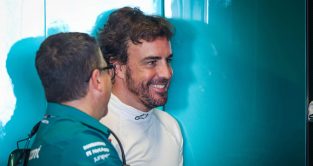 Fernando Alonso smiles with an engineer. Abu Dhabi November 2022.