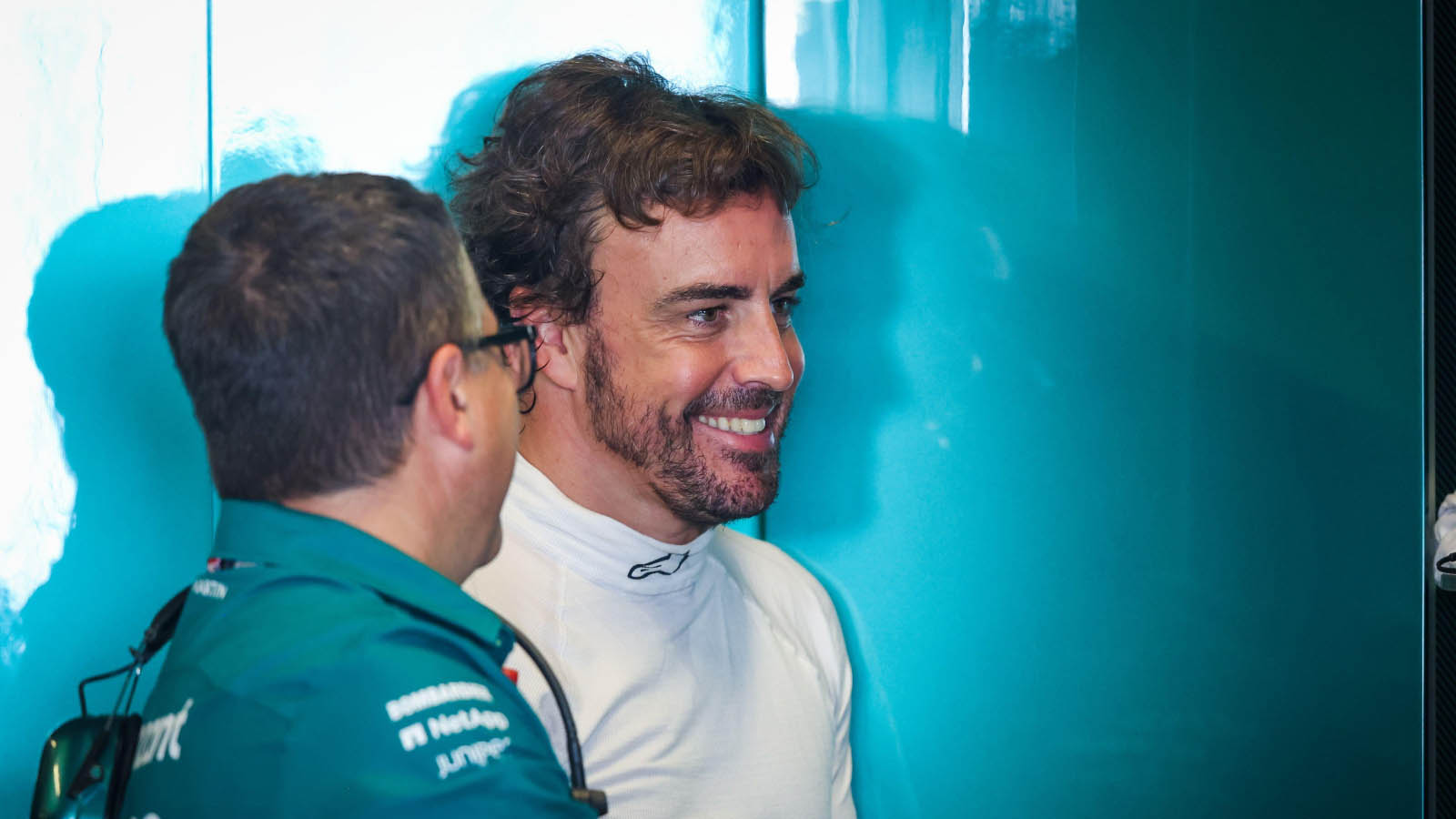 Fernando Alonso smiles with an engineer. Abu Dhabi November 2022.