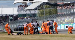 Protestors are dragged away from the Silverstone circuit. Silverstone, July 2022.
