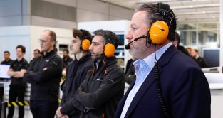 Zak Brown, Andrea Stella and Oscar Piastri watch on as the 2023 McLaren car is fired up. Woking, January 2023.