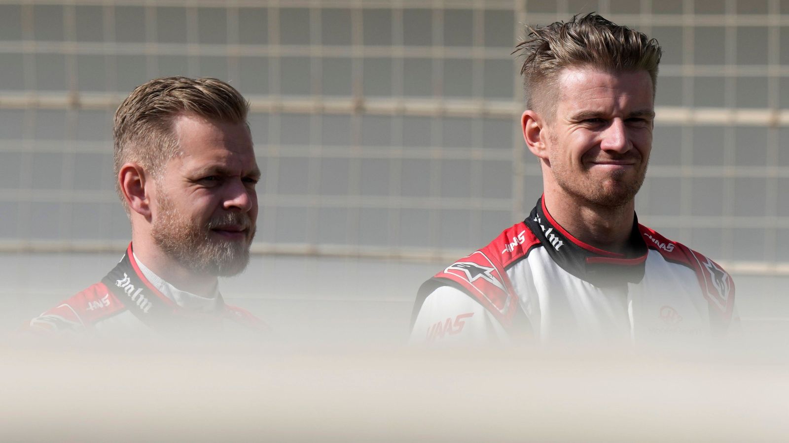 Kevin Magnussen and Nico Hulkenberg, Haas, stood together. Bahrain, February 2023.