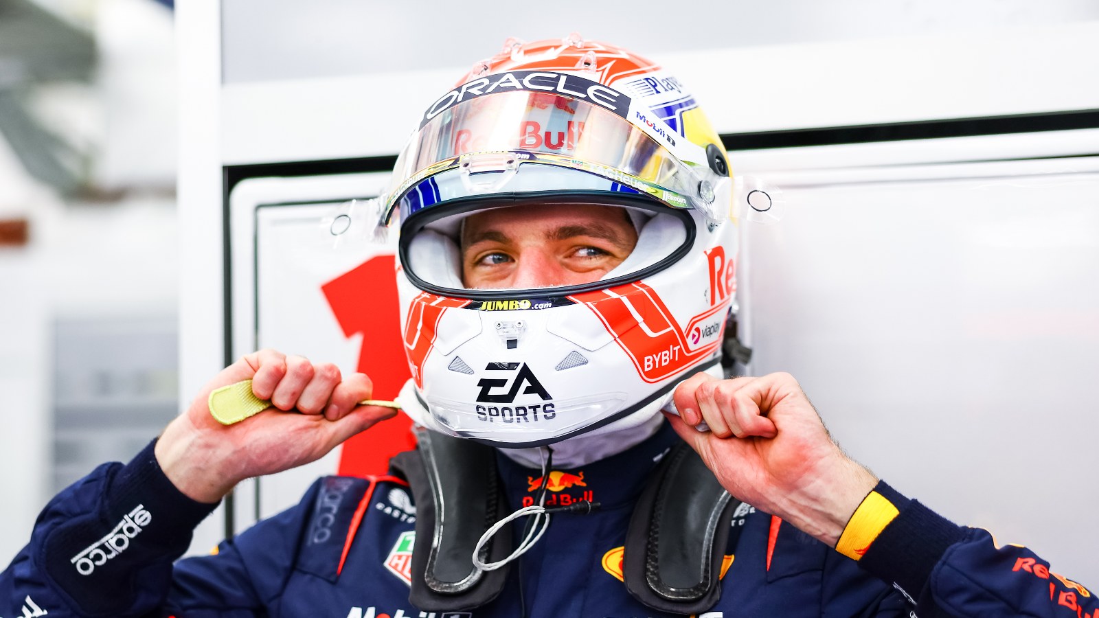 Max Verstappen smiling underneath his helmet. Bahrain, February 2023.
