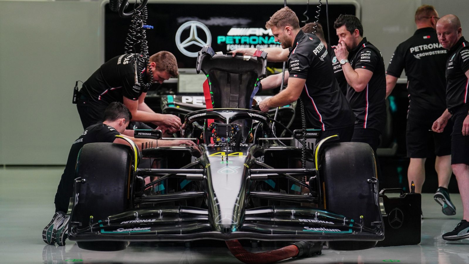 Mercedes mechanics raise the W14's engine cover. Bahrain March 2023