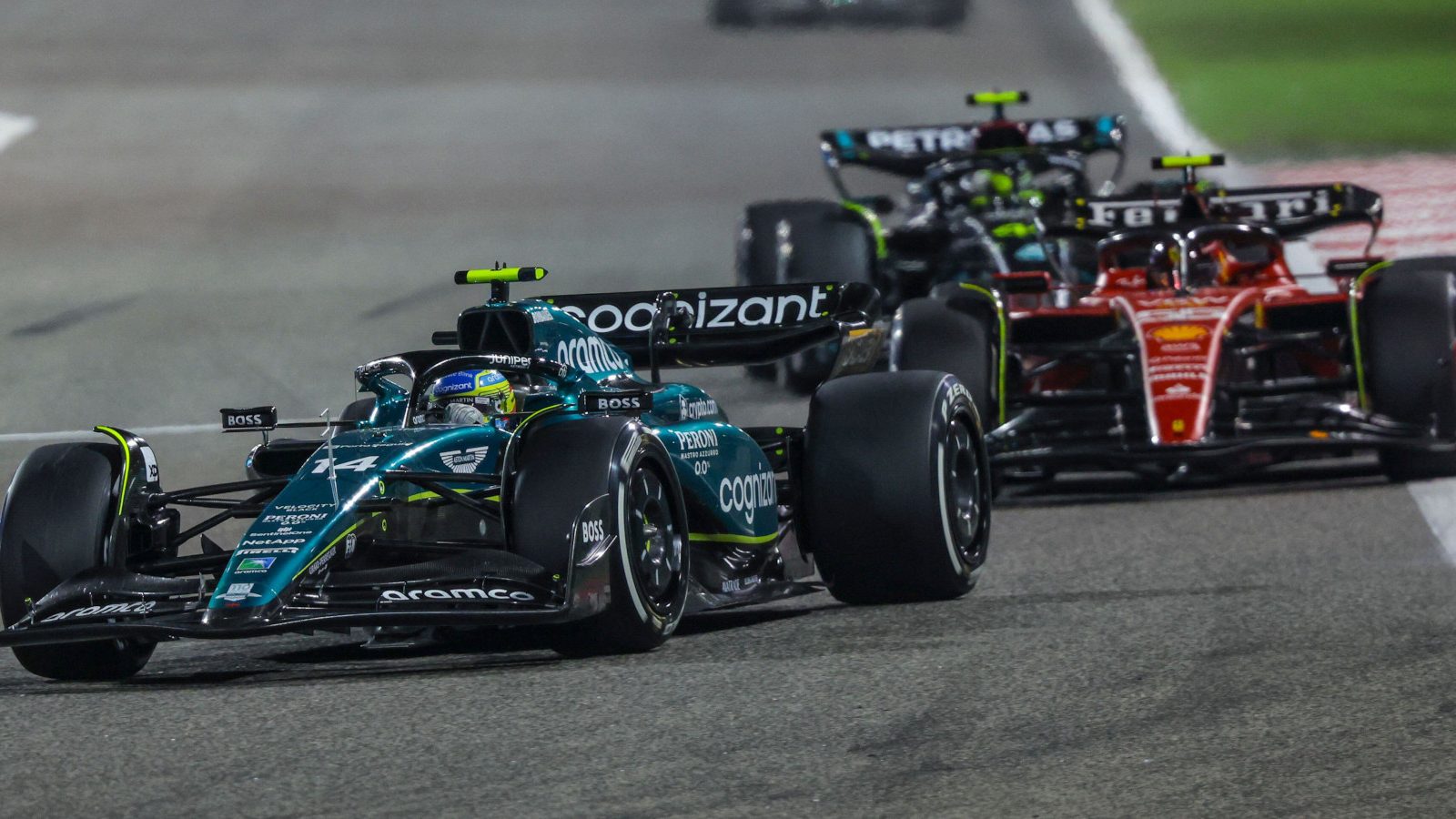 Fernando Alonso leads a Ferrari and Mercedes. Bahrain March 2023