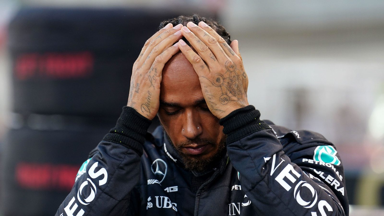 Lewis Hamilton on the grid with his hands to his head. Bahrain March 2023