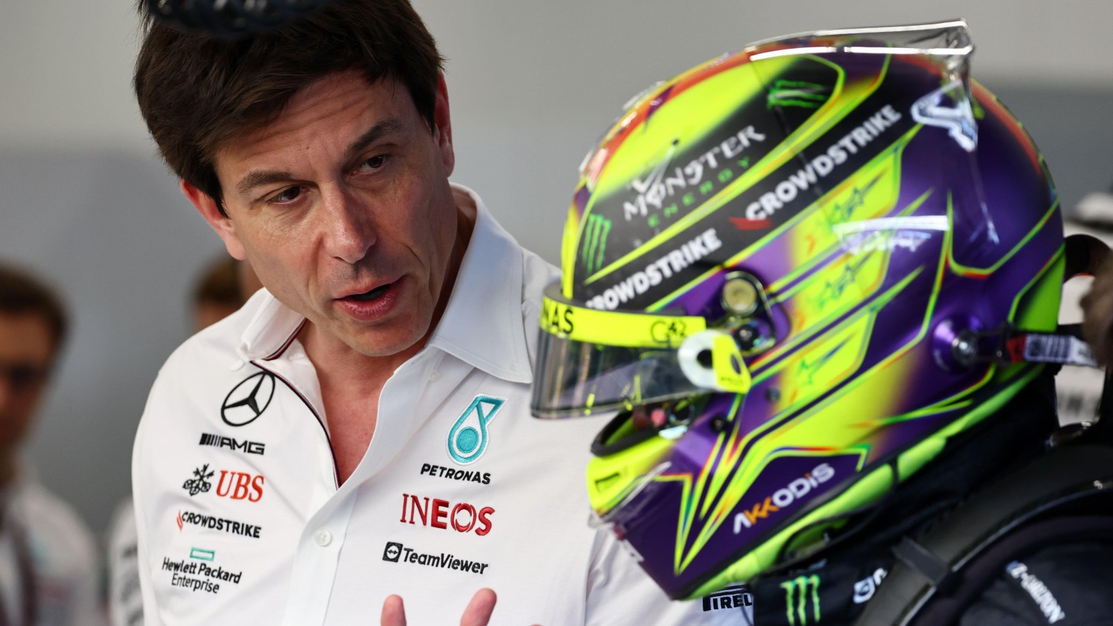 Toto Wolff speaking to Lewis Hamilton who is wearing his helmet. Saudi Arabia, March 2023.