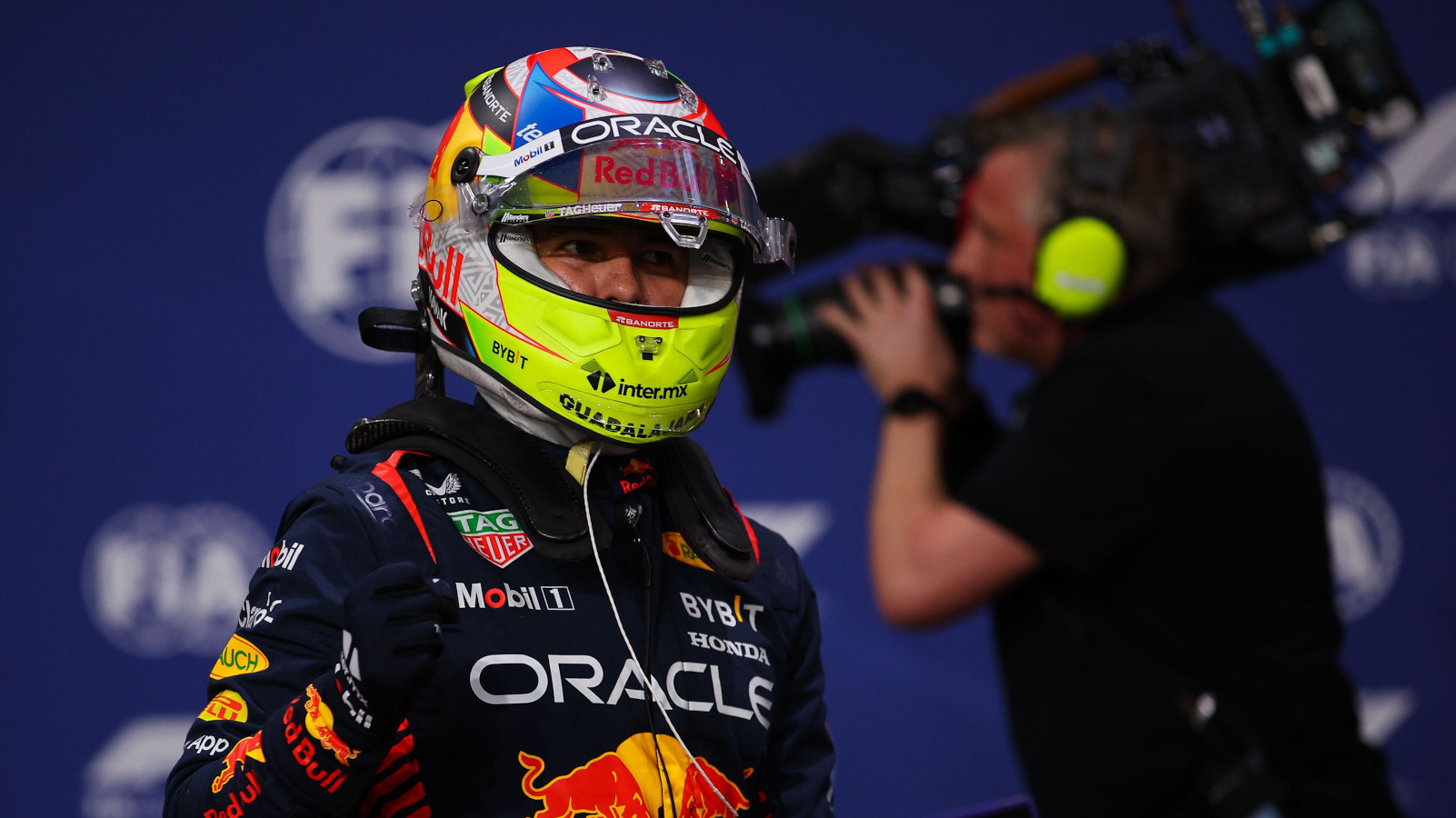 Sergio Perez fist bump with a cameraman in the background. Saudi Arabia March 2023