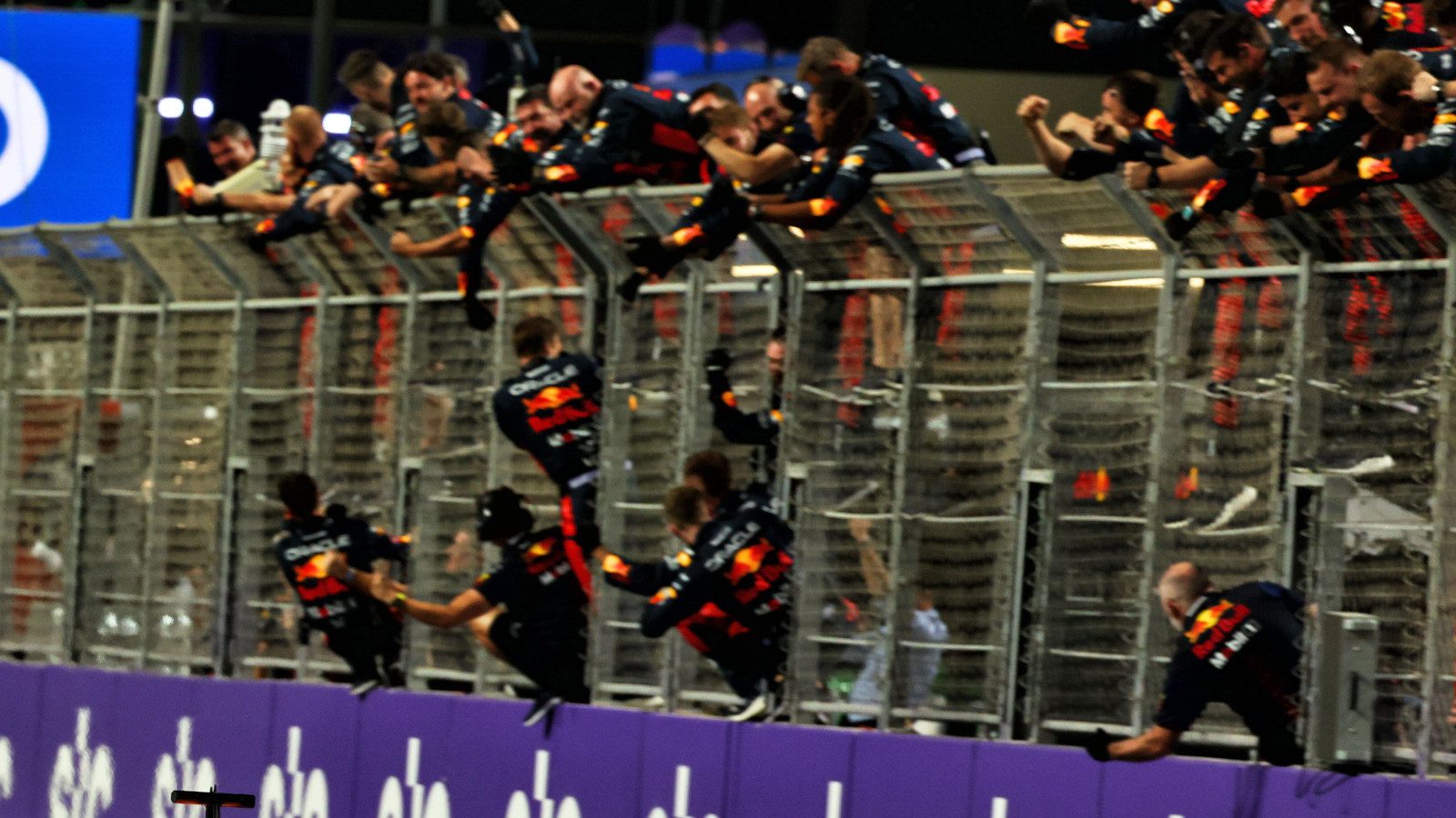 Red Bull mechanics climb the pitlane fencing to celebrate 1-2 result. Saudi Arabia March 2023