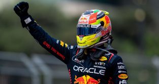 Sergio Perez raises a fist in celebration after winning the Azerbaijan Grand Prix for Red Bull. Baku, 2023.
