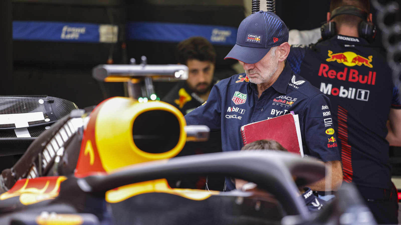 Adrian Newey inspecting the RB19 with his notebook in hand. Bahrain March 2023