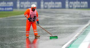 A marshal sweeps rain off track. Imola May 2022.