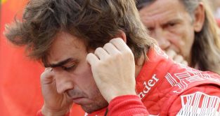 Ferrari driver Fernando Alonso looks tense on the grid shortly before the start of the F1 title-deciding Abu Dhabi Grand Prix.