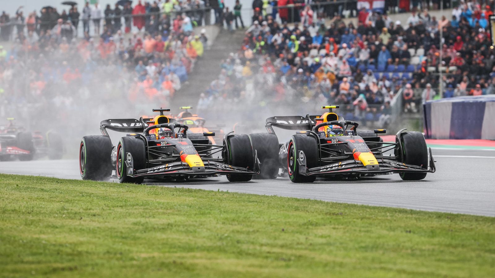 Max Verstappen takes to the grass in battle with Red Bull team-mate Sergio Perez on the opening lap of the Austrian Grand Prix sprint race. Styria, July 2023.