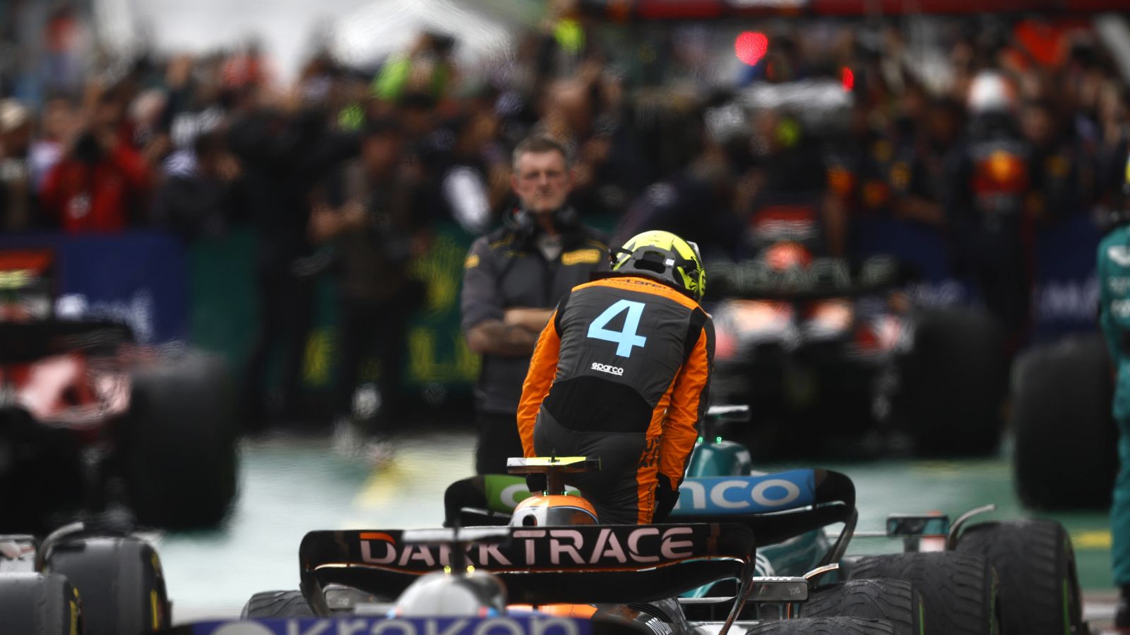 A dejected Lando Norris exits his McLaren MCL60 in parc ferme after the Austrian Grand Prix sprint race. Styria, July 2023.