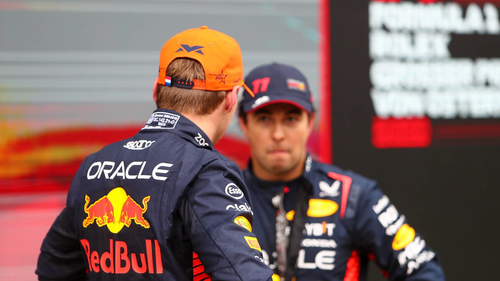 Sergio Perez stares awkwardly at Red Bull team-mate Max Verstappen after their titanic battle in the Austrian Grand Prix sprint race. Styria, July 2023.