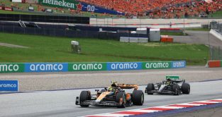 McLaren driver Lando Norris battling with Mercedes' Lewis Hamilton at the Austrian Grand Prix. Spielberg, July 2023.