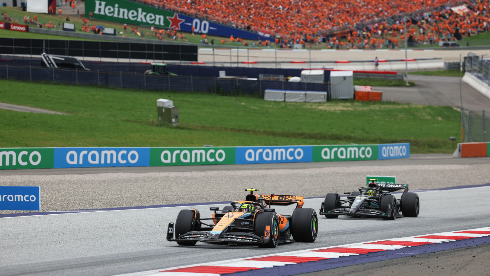 McLaren driver Lando Norris battling with Mercedes' Lewis Hamilton at the Austrian Grand Prix. Spielberg, July 2023.