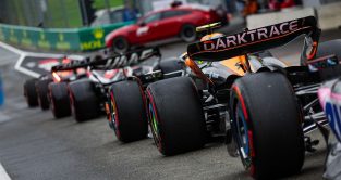 McLaren driver Lando Norris joins a queue of cars leaving the pit lane in Austria in his upgraded MCL60.