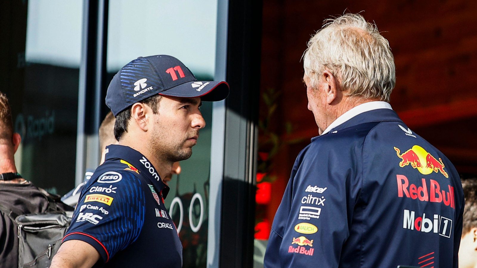 Sergio Perez in serious conversation with Helmut Marko. Britain July 2023