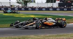 McLaren's Lando Norris racing Mercedes' Lewis Hamilton. Silverstone, July 2023.