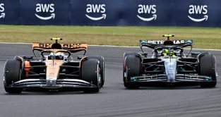 Lando Norris, McLaren, battles Lewis Hamilton, Mercedes. Silverstone July 2023.
