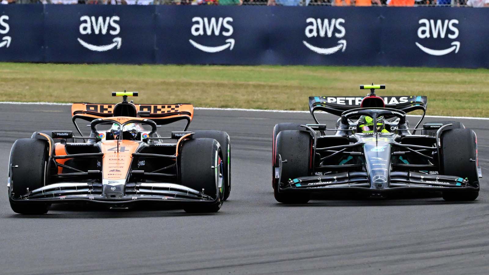 Lando Norris, McLaren, battles Lewis Hamilton, Mercedes. Silverstone July 2023.