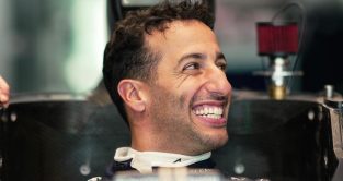 Daniel Ricciardo smiling during a seat fit. July 2023.