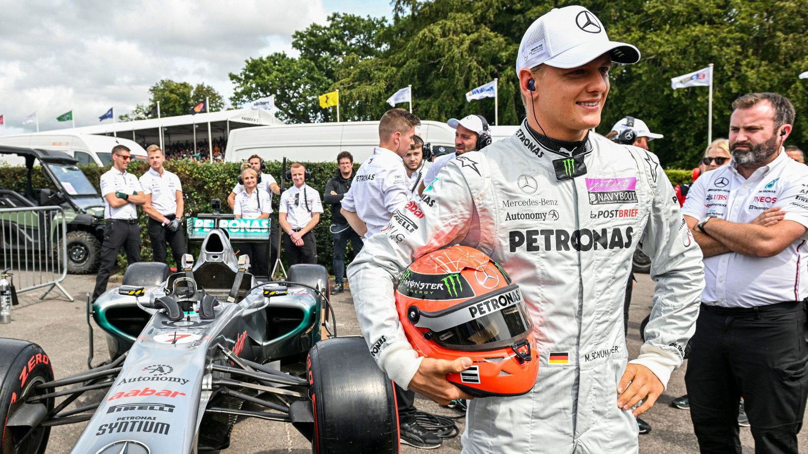 Mick Schumacher with Michael Schumacher's 2011 W02. Goodwood July 2023