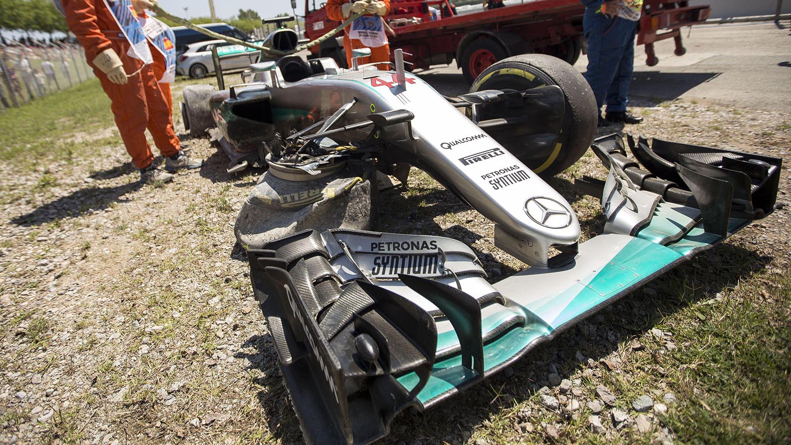 Marshals recover Lewis Hamilton's crashed car after Nico Rosberg collision