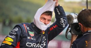 Max Verstappen smiling as he pulls off his fireproofs. Belgium July 2023