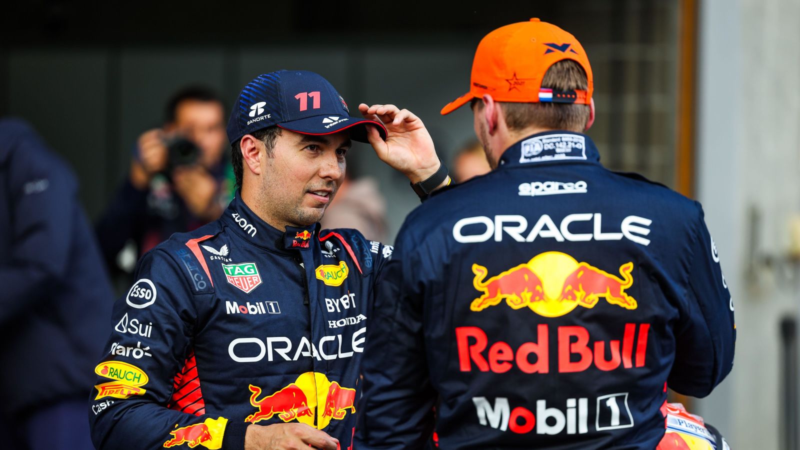 年代ergio Perez in conversation with Red Bull team-mate Max Verstappen after Belgian Grand Prix qualifying. Spa, July 2023.
