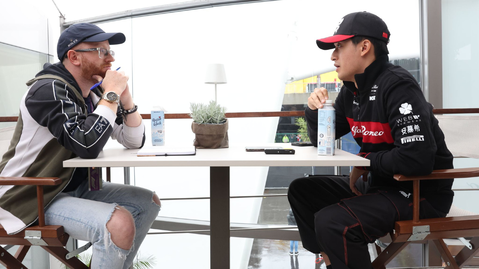 Alfa Romeo's Zhou Guanyu at the Belgian Grand Prix, speaking with PlanetF1.com's Thomas Maher