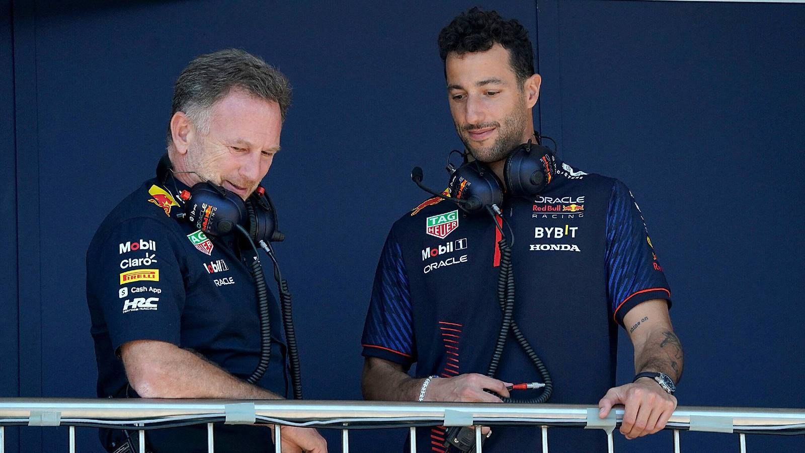 Christian Horner and Daniel Ricciardo, Red Bull, looking down. Monaco, May 2023.