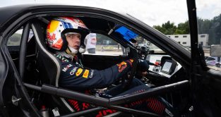 Max Verstappen sits in the cockpit of a drift car.