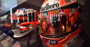A row of Michael Schumacher helmets together.