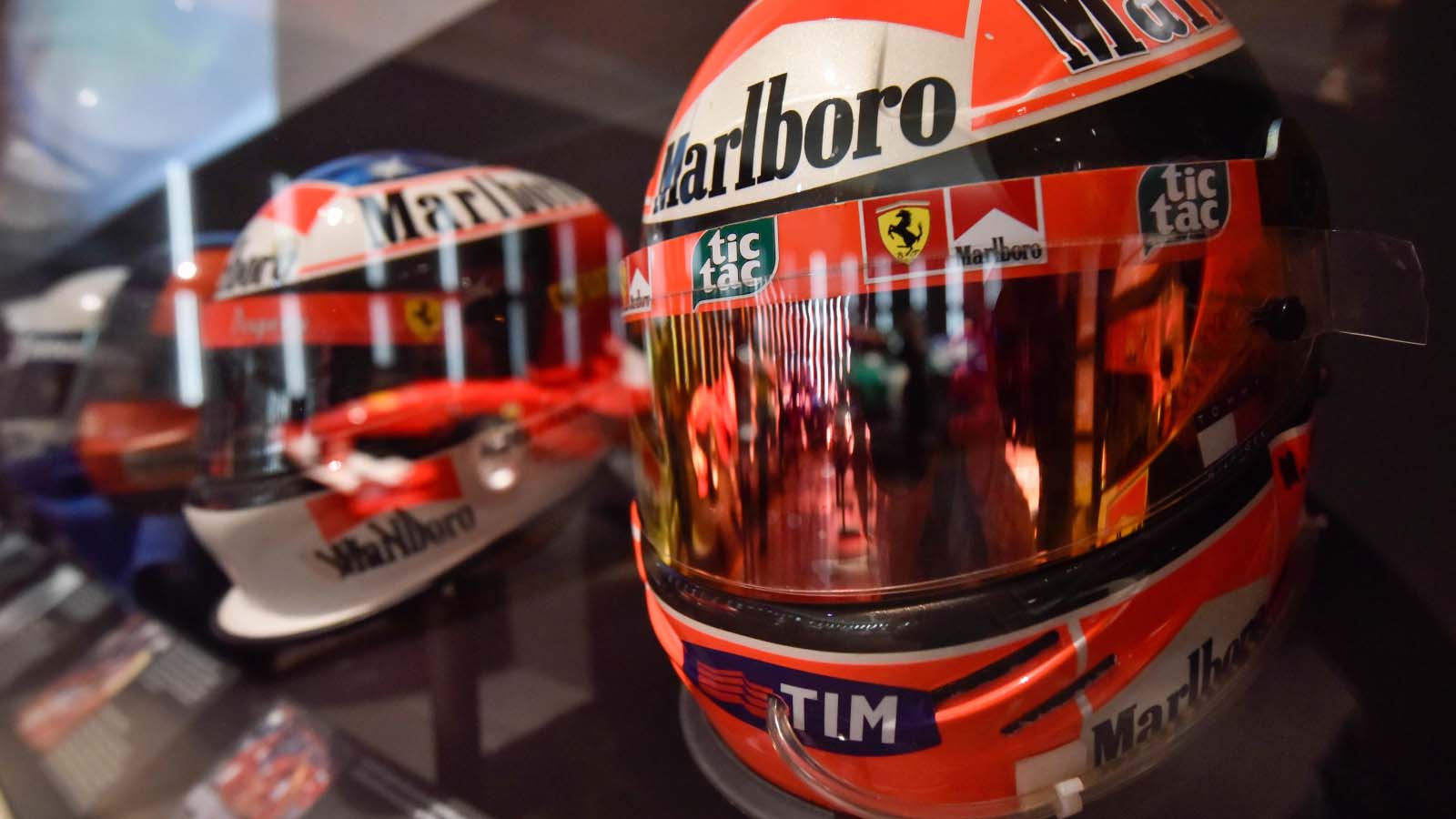 A row of Michael Schumacher helmets together.
