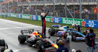 Max Verstappen standing on his Red Bull RB19 to celebrate his Dutch GP win.