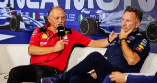 Ferrari team boss Fred Vasseur explains during a press conference while Christian Horner ponders.